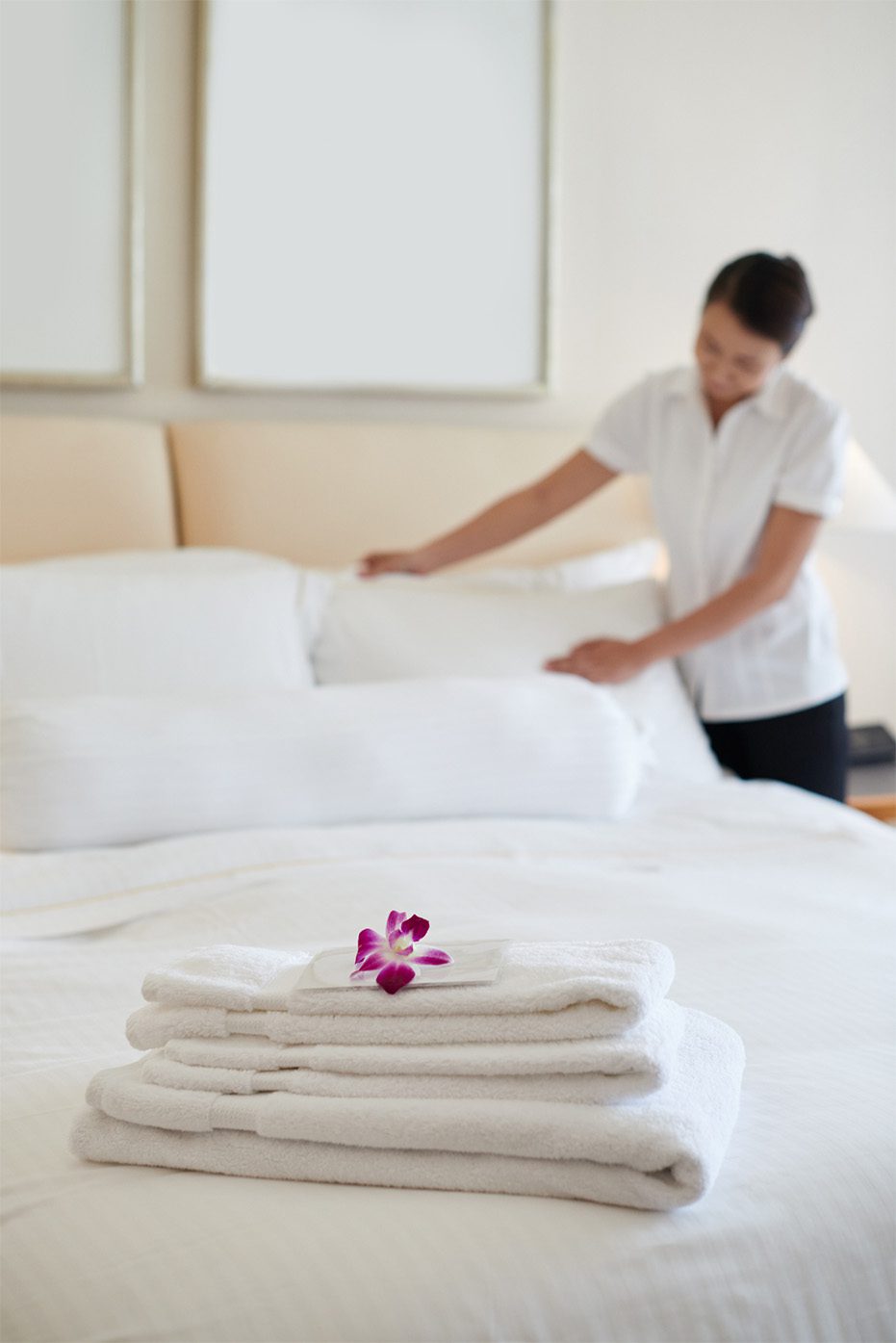 Woman setting bed linens